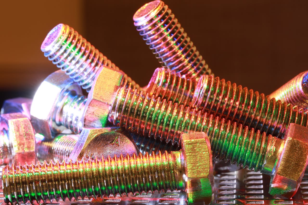 who-we-are Close-up shot of vibrant, multi-colored metal bolts stacked together, highlighting industrial design.
